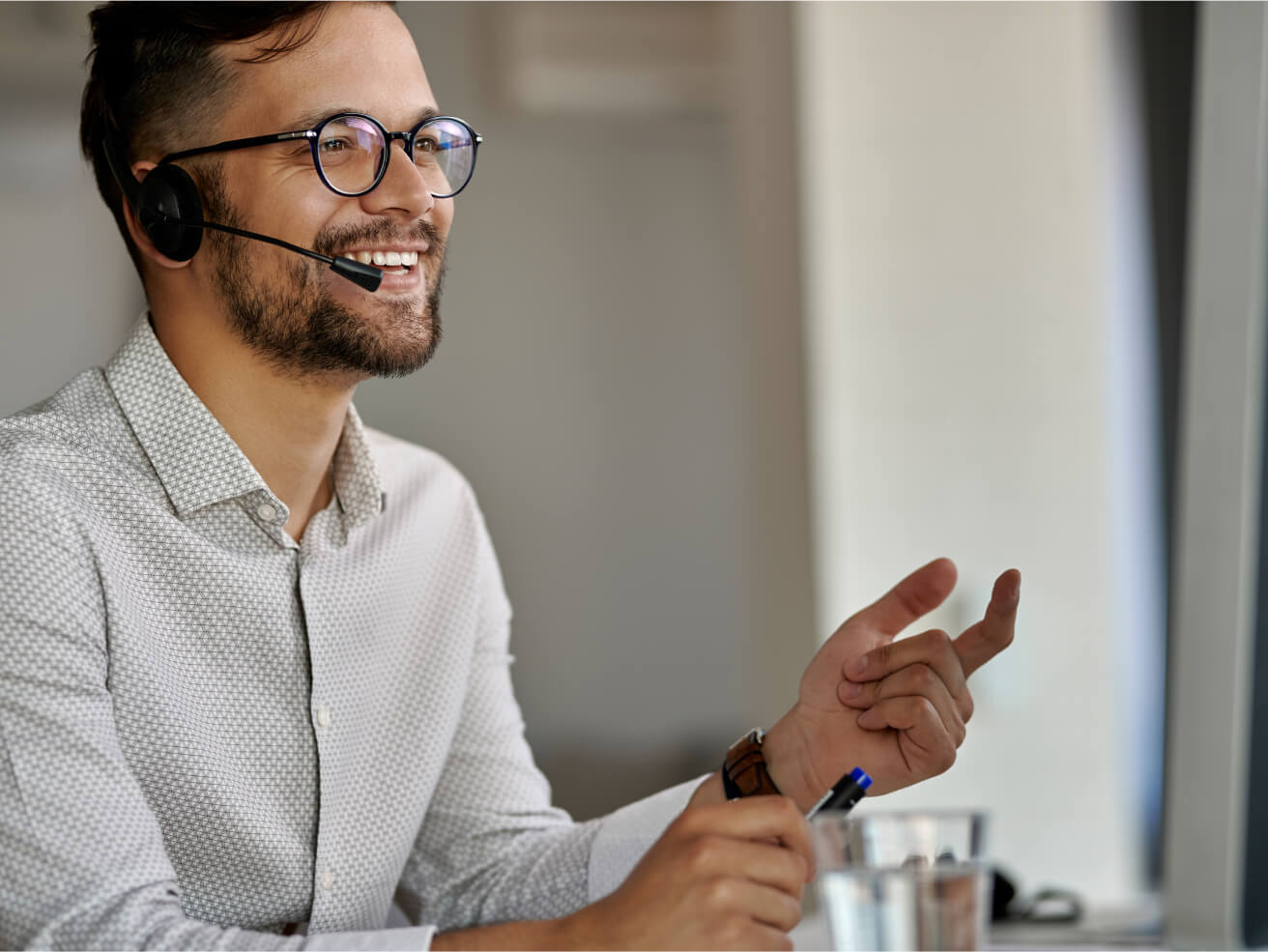 happy-call-center-agent-using-computer-while-communicating-with-clients-working-office 1 (1).jpg